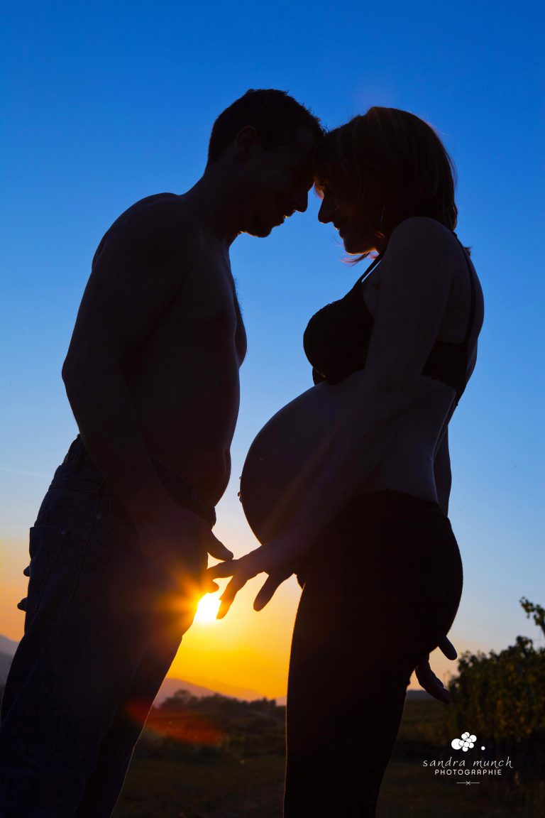 photo femme enceinte et homme en silouette au coucher du soleil
